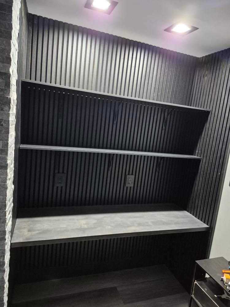 Custom built-in desk with concrete top and slat wall