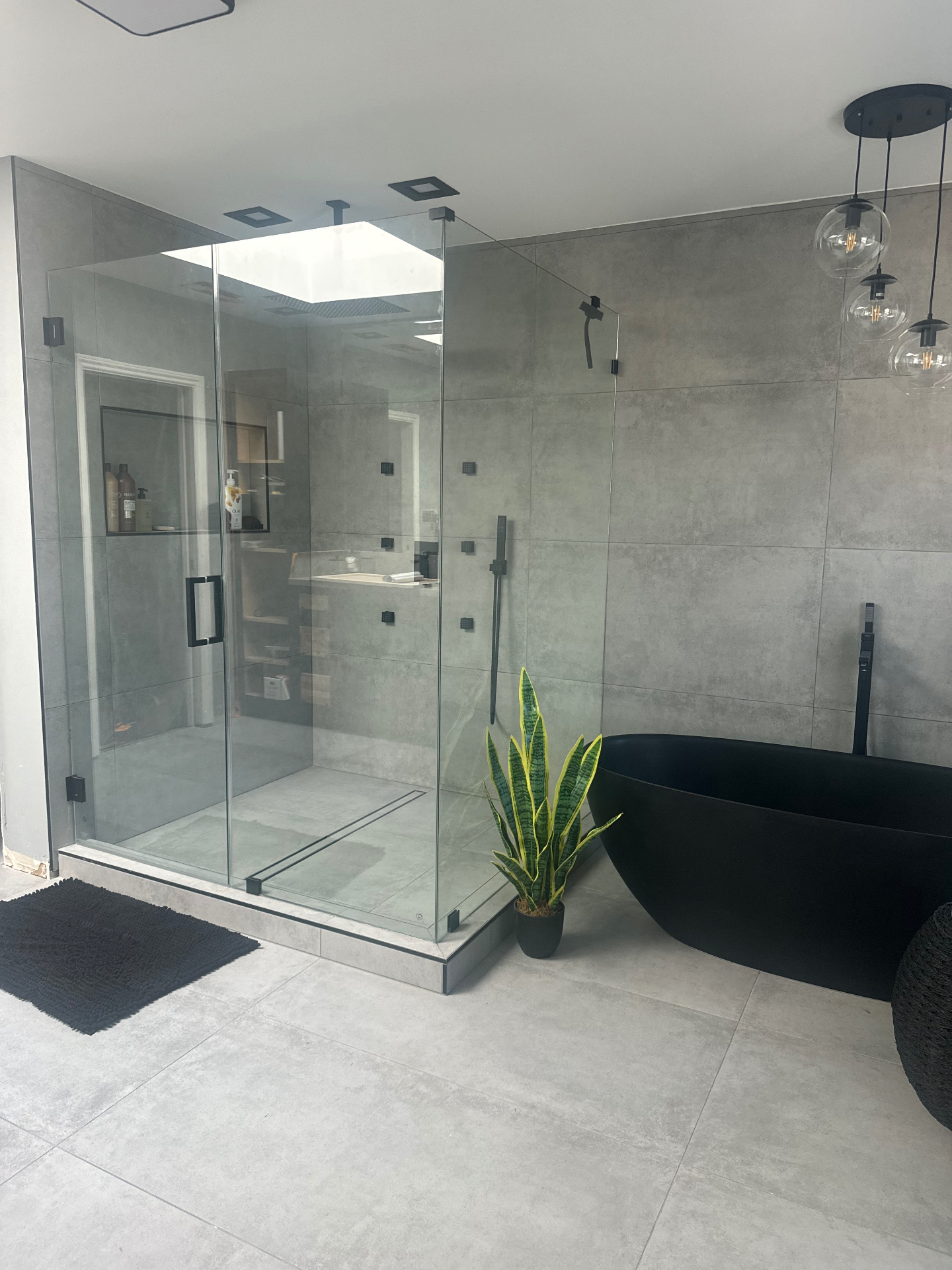 Large-format concrete tile in a walk-in shower