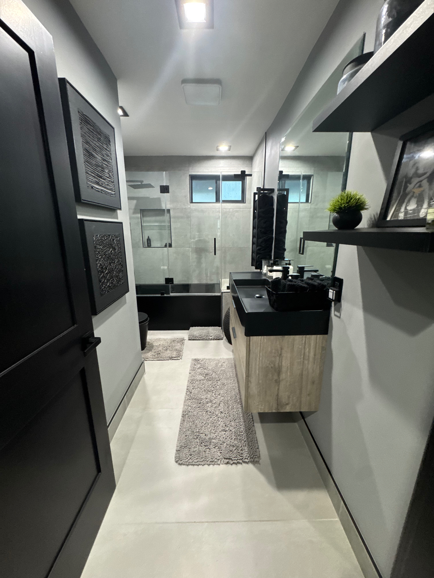 Fully remodeled modern bathroom with floating wood vanity